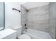 Modern bathroom features a sleek vanity, toilet, and shower with decorative tile surround at 201 La Paz Dr, Kissimmee, FL 34743
