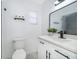 Modern bathroom showcasing a white vanity with black hardware and a decorative mirror at 201 La Paz Dr, Kissimmee, FL 34743