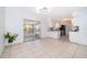 Open floor plan with tile flooring throughout and view of the kitchen and screened in patio at 201 La Paz Dr, Kissimmee, FL 34743