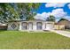 Charming single-story home featuring a well-manicured lawn and a freshly painted exterior at 201 La Paz Dr, Kissimmee, FL 34743