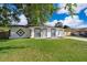 Charming single-story home featuring a well-manicured lawn and a freshly painted exterior at 201 La Paz Dr, Kissimmee, FL 34743