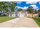 Charming single-story home with a large driveway, garage, and well-maintained front yard at 201 La Paz Dr, Kissimmee, FL 34743