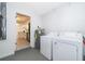 Functional laundry room with washer, dryer, and water heater, next to the kitchen at 201 La Paz Dr, Kissimmee, FL 34743