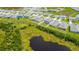 Aerial view of properties in a neighborhood near a dark pond at 2705 Grandbury Grove Rd, Lakeland, FL 33811