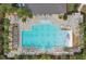 An overhead shot of a community pool with lounge chairs, tables, and umbrellas for sunny days at 2705 Grandbury Grove Rd, Lakeland, FL 33811