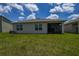 This backyard has a well manicured lawn and a screened patio at 2705 Grandbury Grove Rd, Lakeland, FL 33811