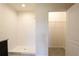 Bright bathroom featuring a walk-in shower with white tile surround and large closet at 2705 Grandbury Grove Rd, Lakeland, FL 33811