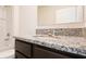 Modern bathroom features granite countertop and a shower with white subway tile at 2705 Grandbury Grove Rd, Lakeland, FL 33811