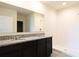 Modern bathroom with dual sinks, granite countertop and walk-in shower at 2705 Grandbury Grove Rd, Lakeland, FL 33811