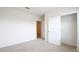 Bedroom has neutral carpet and an open closet with a single rack shelf at 2705 Grandbury Grove Rd, Lakeland, FL 33811
