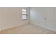 Cozy bedroom with carpet flooring and a window letting in natural light at 2705 Grandbury Grove Rd, Lakeland, FL 33811