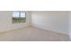 Bright bedroom with a large window and neutral colored carpeting at 2705 Grandbury Grove Rd, Lakeland, FL 33811
