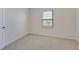 Bedroom with carpet flooring and a window for natural lighting at 2705 Grandbury Grove Rd, Lakeland, FL 33811