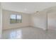 Open bedroom with tile flooring and lots of natural light from a window at 2705 Grandbury Grove Rd, Lakeland, FL 33811