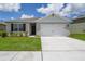 Charming single-story home featuring a two-car garage, well-maintained lawn, and traditional architectural details at 2705 Grandbury Grove Rd, Lakeland, FL 33811