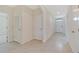 Entryway with tiled floors and neutral-colored walls leads to multiple rooms at 2705 Grandbury Grove Rd, Lakeland, FL 33811