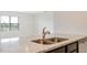 Granite countertops and stainless steel sink create a sleek look in this kitchen at 2705 Grandbury Grove Rd, Lakeland, FL 33811