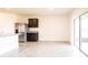 Modern kitchen adjacent to dining area with stainless steel refrigerator, granite countertops, and sliding glass doors at 2705 Grandbury Grove Rd, Lakeland, FL 33811