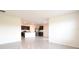 Open floor plan showcasing the kitchen with granite countertops and stainless steel appliances, connected to living area at 2705 Grandbury Grove Rd, Lakeland, FL 33811