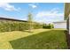 Expansive backyard featuring green grass and landscaping, enhancing the property's outdoor appeal at 2748 Greenlands St, St Cloud, FL 34772