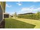 Spacious backyard with lush green grass and privacy provided by mature hedges and landscaping at 2748 Greenlands St, St Cloud, FL 34772