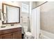 Bathroom featuring a vanity, toilet, and shower with a curtain, offering a functional and clean space at 2748 Greenlands St, St Cloud, FL 34772
