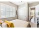 Bedroom featuring a bed, closet, shuttered windows, and a view into the hallway, creating a spacious and inviting ambiance at 2748 Greenlands St, St Cloud, FL 34772