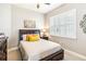 Inviting bedroom with a white bed, shuttered windows, a dresser and nightstand providing a cozy, serene atmosphere at 2748 Greenlands St, St Cloud, FL 34772