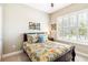 Charming bedroom featuring a bed with floral patterned bedding, a window with shutters, and a cozy, inviting atmosphere at 2748 Greenlands St, St Cloud, FL 34772