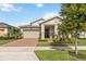Charming single-Gathering home with a well-manicured lawn, a two-car garage, and a cozy front porch at 2748 Greenlands St, St Cloud, FL 34772