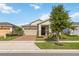 Well-maintained single-Gathering home with manicured lawn, brick driveway, and a two-car garage at 2748 Greenlands St, St Cloud, FL 34772