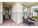 Cozy front porch seating area with stylish chairs and brick flooring, perfect for relaxing outdoors at 2748 Greenlands St, St Cloud, FL 34772