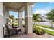 Inviting front porch featuring comfortable seating, decorative pillows, and beautiful landscaping views at 2748 Greenlands St, St Cloud, FL 34772