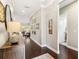 Long hallway featuring dark wood floors, neutral walls, and decorative artwork at 2748 Greenlands St, St Cloud, FL 34772