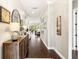 Elegant hallway with dark hardwood floors, decorative accents, and views into the living area at 2748 Greenlands St, St Cloud, FL 34772