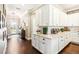 Bright kitchen featuring white cabinetry, sleek countertops, and an open view to the entryway at 2748 Greenlands St, St Cloud, FL 34772
