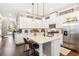 Spacious white kitchen with stainless steel appliances, an island with seating, and lots of counter space at 2748 Greenlands St, St Cloud, FL 34772