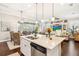 Open kitchen and dining area with white cabinets, a kitchen island, and a view of the living area at 2748 Greenlands St, St Cloud, FL 34772