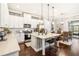 Stylish kitchen featuring white cabinetry, stainless steel appliances, and a center island with seating at 2748 Greenlands St, St Cloud, FL 34772