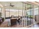 Inviting lanai showcasing brick floors, cozy seating, and a ceiling fan for relaxing outdoor living at 2748 Greenlands St, St Cloud, FL 34772