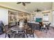 Screened in lanai with brick floors, ceiling fans, outdoor seating, and sliders leading into the house at 2748 Greenlands St, St Cloud, FL 34772