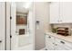 Bright laundry room offers white cabinets, counter space, and a view into the connected laundry area with machines at 2748 Greenlands St, St Cloud, FL 34772