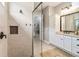 Modern glass enclosed shower with tile surround, and a niche for toiletries at 2748 Greenlands St, St Cloud, FL 34772