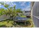 Fenced backyard with grass, landscaping, trampoline, and parked four-wheeler vehicle at 2820 Avian Loop, Kissimmee, FL 34741