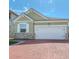 Charming home featuring a brick driveway, a two car garage, and stone veneer on the facade at 2820 Avian Loop, Kissimmee, FL 34741