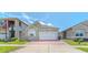 Charming single Gathering home featuring a brick driveway, well-kept lawn, and a two car garage at 2820 Avian Loop, Kissimmee, FL 34741