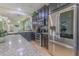Modern kitchen with stainless appliances, granite counters, dark cabinets, and tile flooring at 2820 Avian Loop, Kissimmee, FL 34741