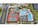 Aerial view of community amenities including tennis courts, playground, and resort-style pool with slides at 3038 Camden Way, Davenport, FL 33837