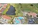 Aerial view of the golf course and community pool with slides in a beautiful community at 3038 Camden Way, Davenport, FL 33837