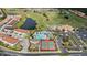 Aerial view of community amenities including tennis courts, playground, pool with slides and golf course at 3038 Camden Way, Davenport, FL 33837